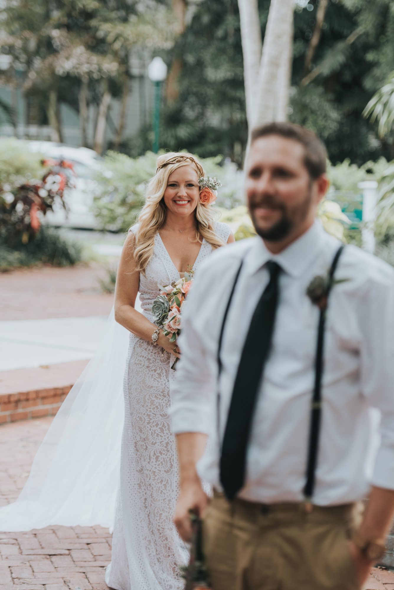 Amy and Teddy's Key West wedding captured by an experienced photographer at Fort Zachary and Truman Little White House while the couple walks down a brick walkway.
