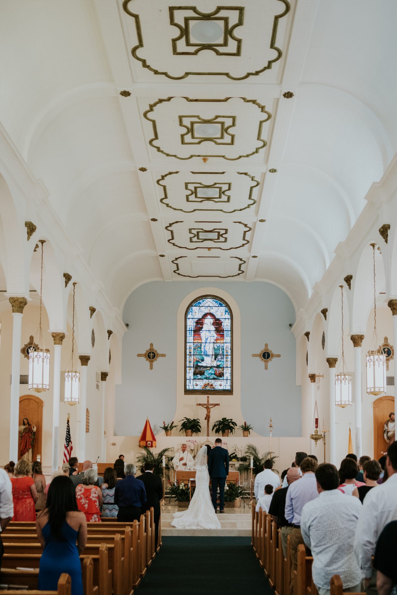 Erika and David, Key West Wedding Photographer, capturing a bride and groom in the aisle of St Mary's.