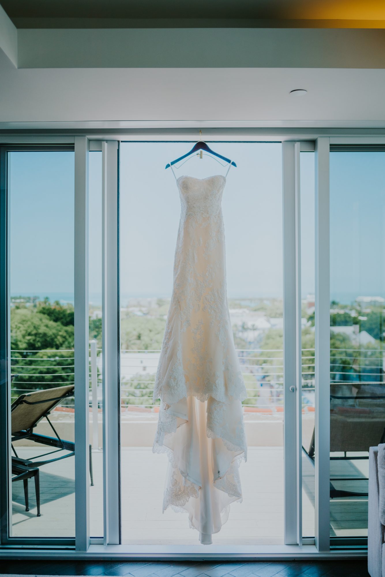 A wedding dress hangs on the balcony of a hotel room in Key West.