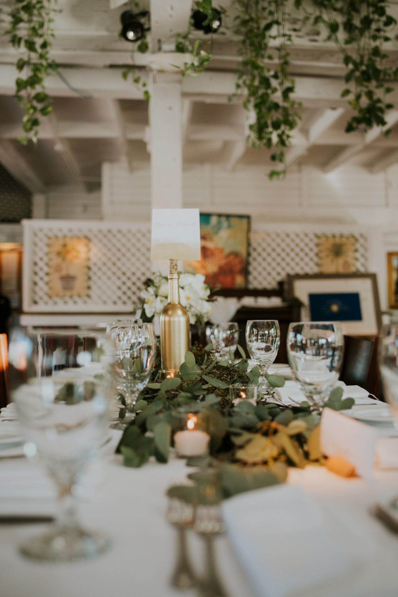 A table setting with greenery and wine glasses captured by Erika & David, Key West wedding photographers at St Mary's + Rooftop Cafe.
