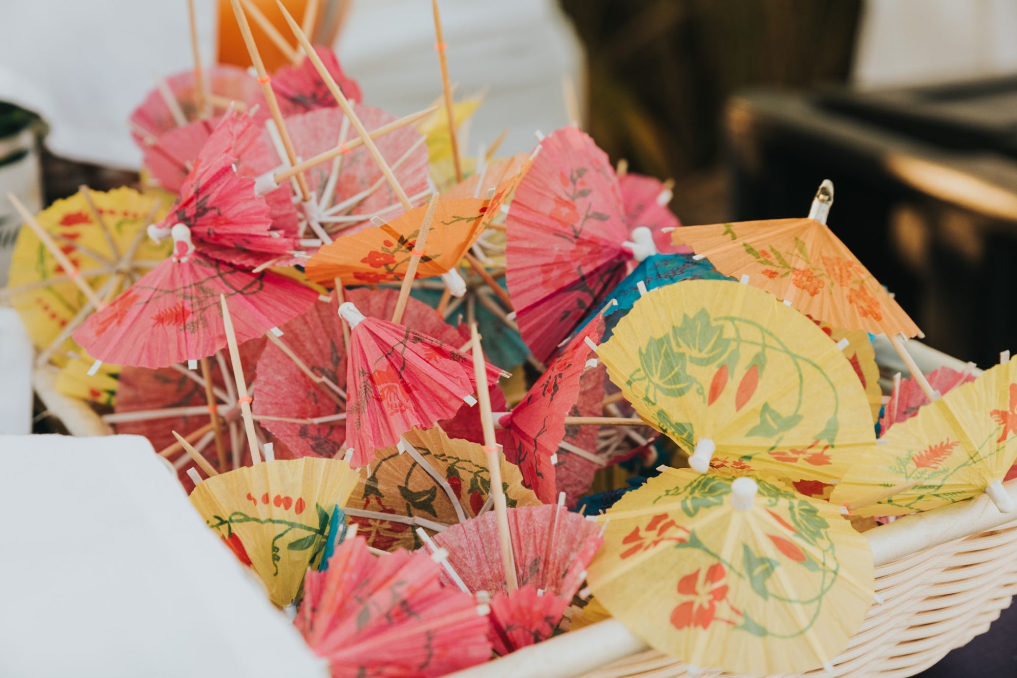 A wicker basket filled with colorful paper umbrellas for an Islamorada wedding at the Postcard Inn at Holiday Isle.
