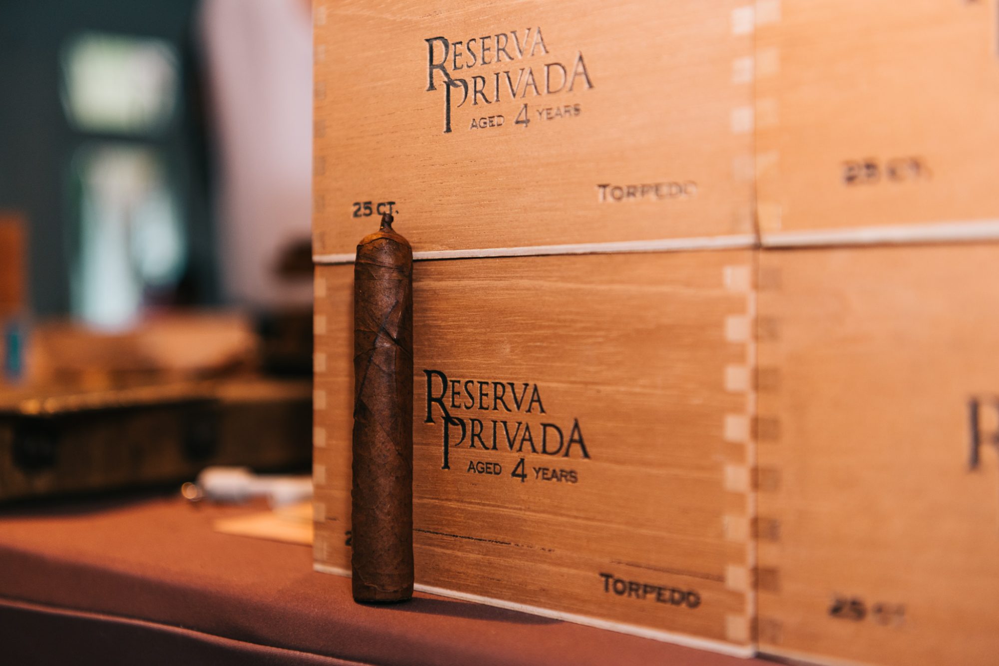 Freya and Jamie's Key West wedding with a box of cigars sitting on a table.