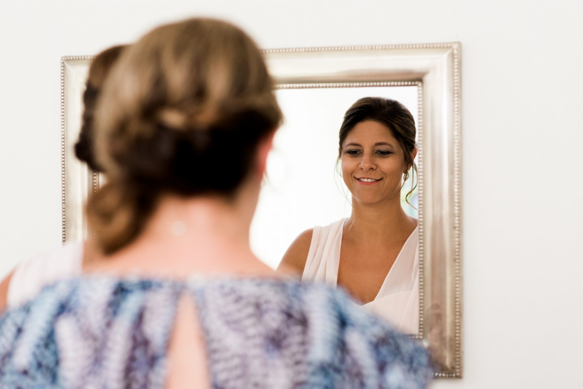 A Key West bride admiring herself in the mirror.