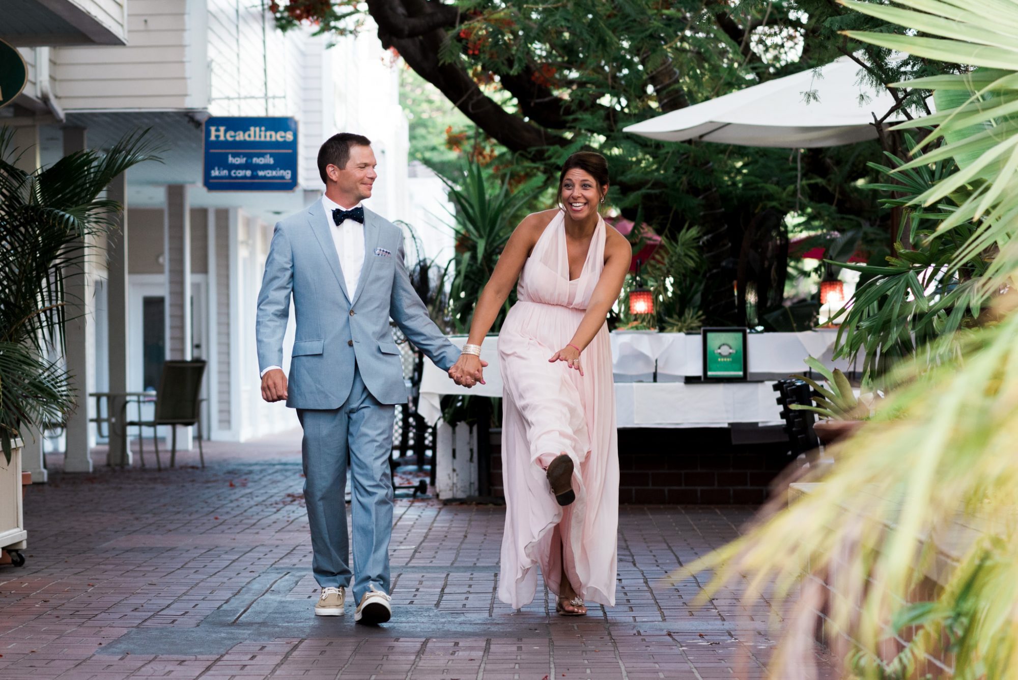 Freya and Jamie, a bride and groom, walking down a sidewalk on their Key West Wedding.