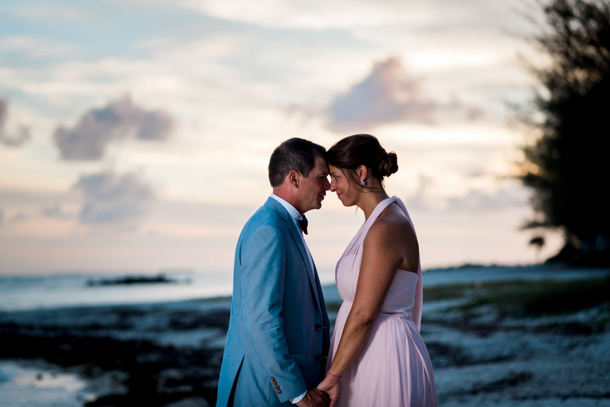 A Key West wedding with Freya and Jamie, featuring a bride and groom standing on the beach at sunset.