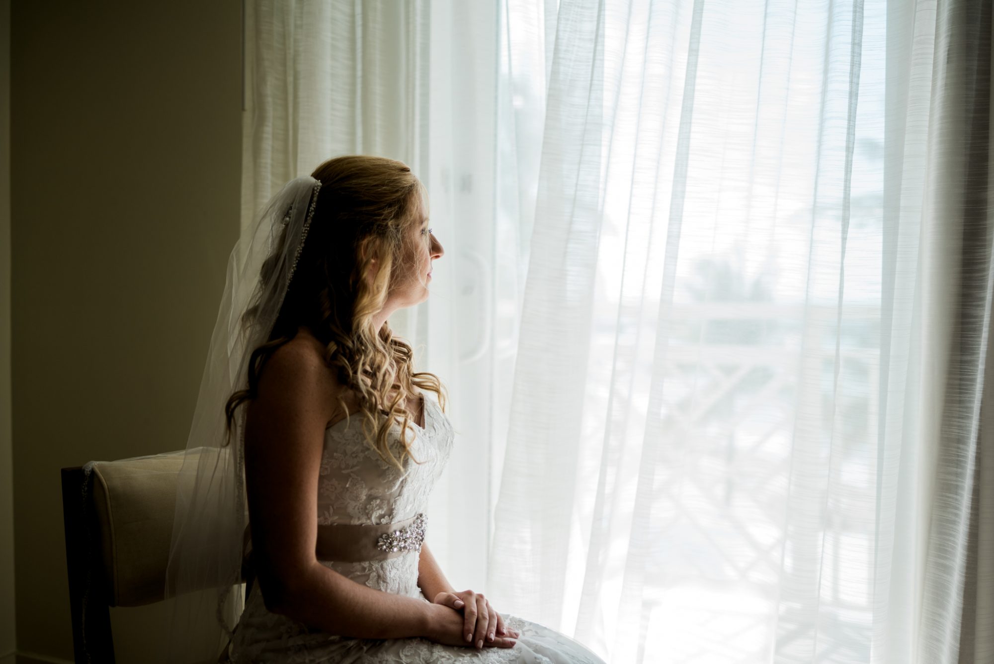 A bride sitting in a chair at Reach Resort, Key West.