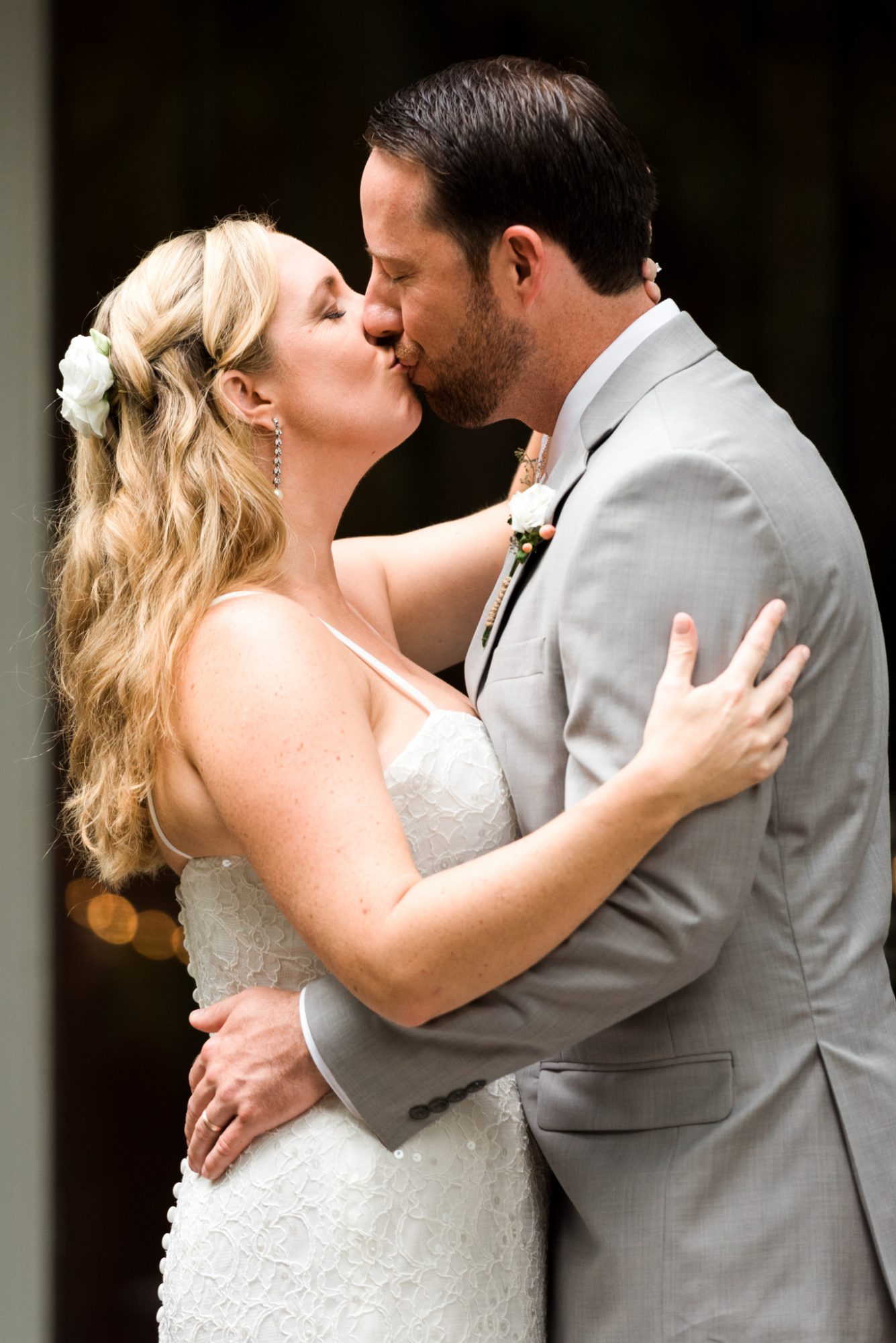 A Key West bride and groom sharing a romantic kiss in front of the beautiful Audubon House and Gardens during their wedding ceremony.