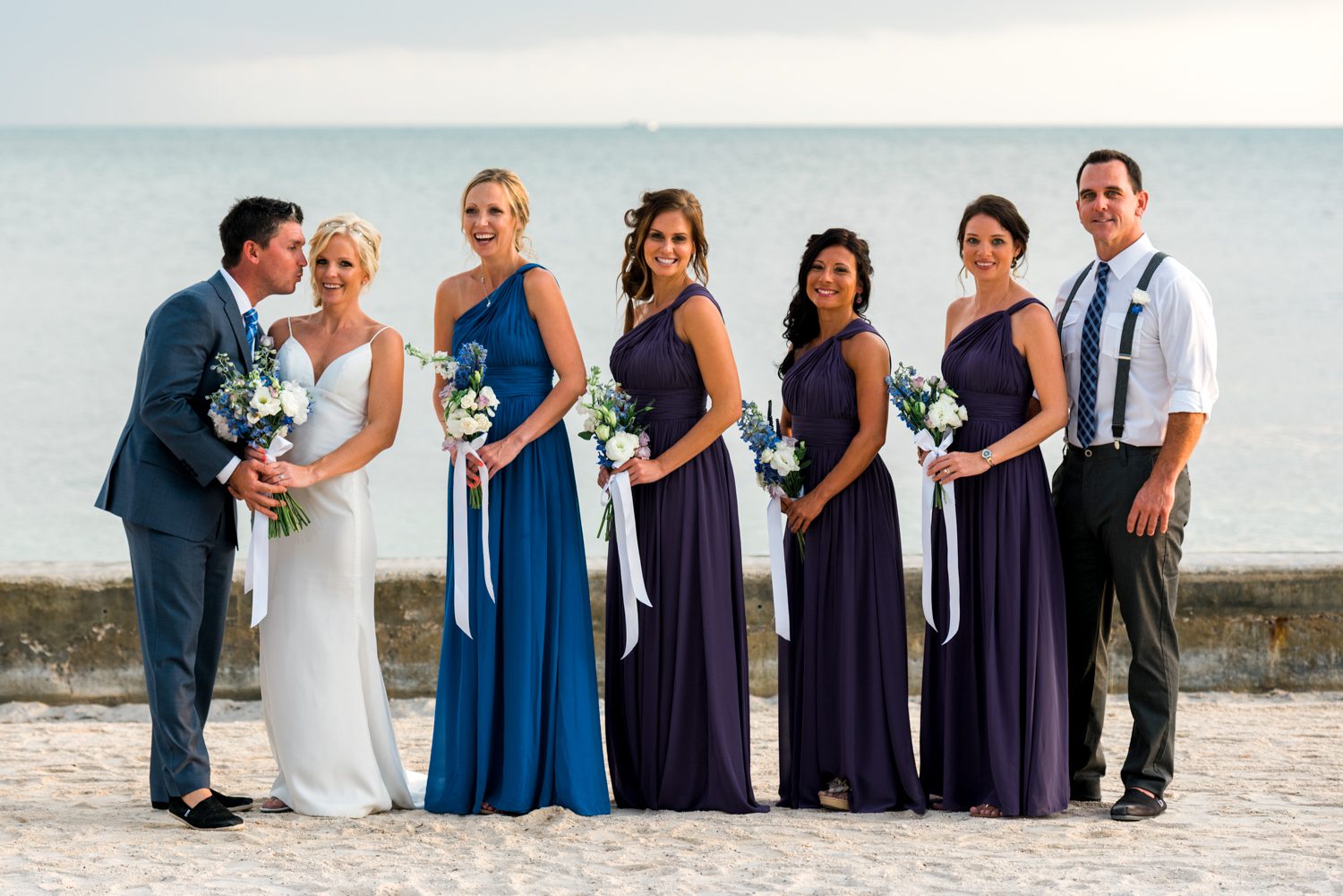 A group of bridesmaids and groomsmen at the Key West Garden Club wedding venue.