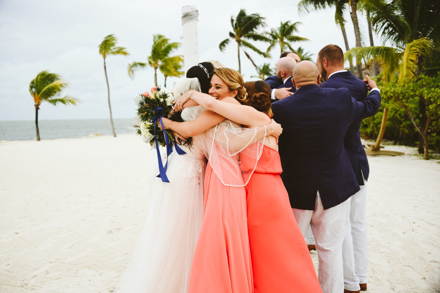 A group of bridesmaids hugging on the beach in the Florida Keys.