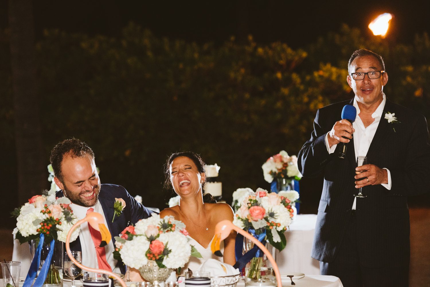 A Florida Keys wedding reception at the Postcard Inn with a bride and groom in fits of laughter.