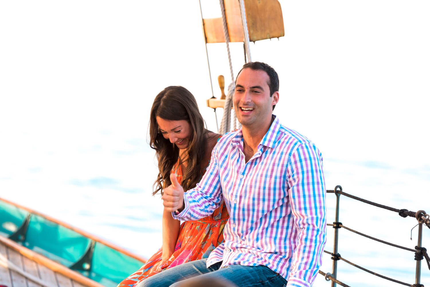 A man and woman enjoying a romantic moment on the deck of a boat during their Key West engagement photography session.