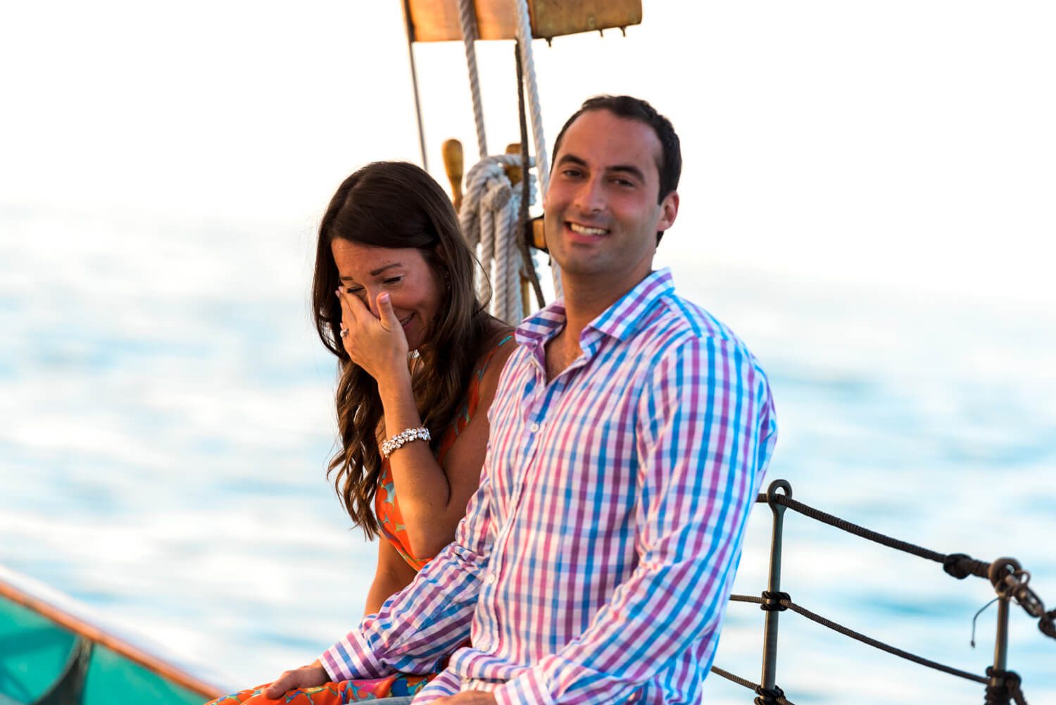 Elizabeth and Alex on a boat, laughing during their Key West engagement photography session.