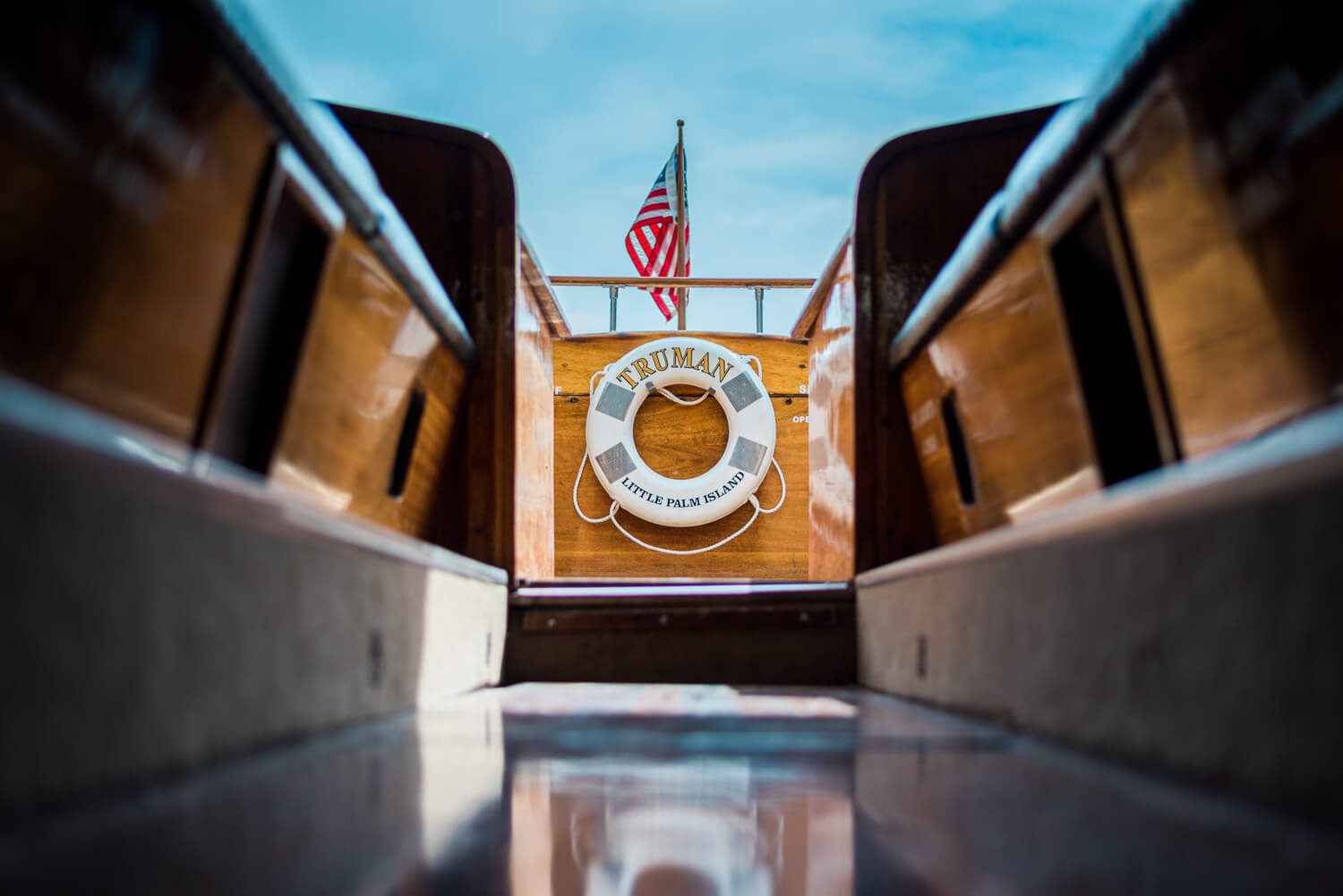 A wooden boat with an American flag on it, captured by a Florida Keys wedding photographer during a Little Palm Island wedding.