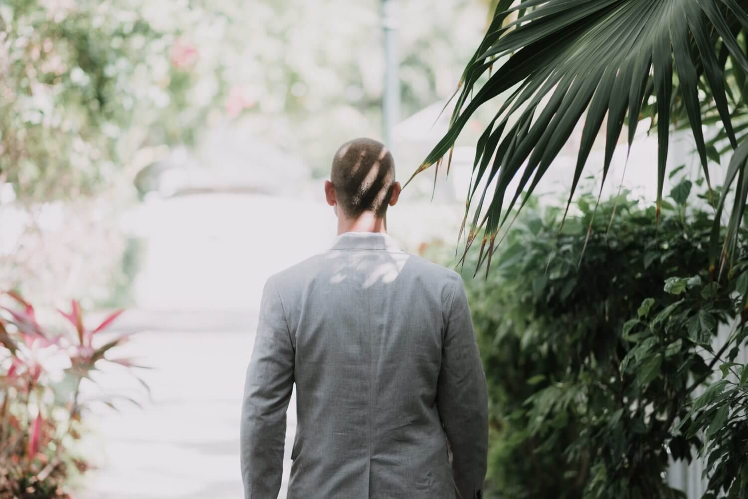 A man in a suit walking down a path in Key West.