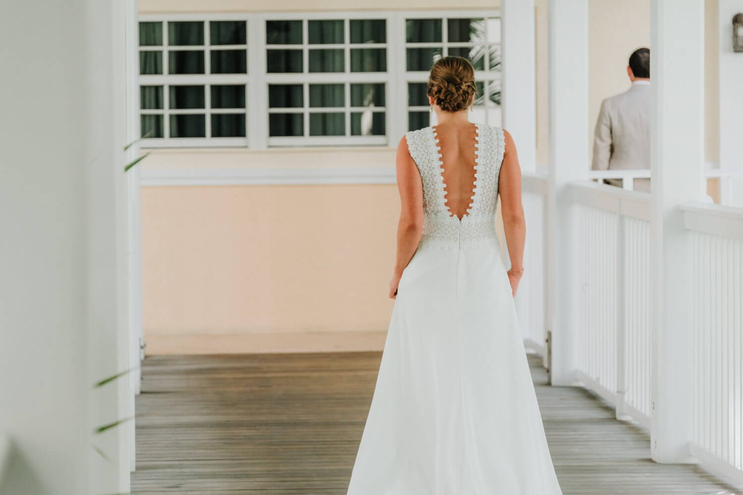 A bride walks down the porch of Ocean Key Resort Spa in Key West, wearing a white wedding dress.