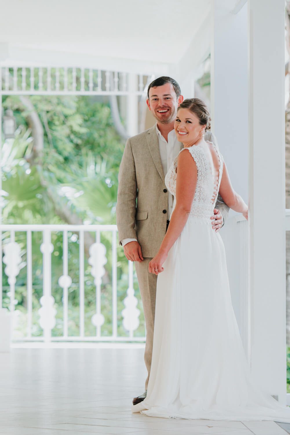 A couple in their wedding attire standing on a porch at the Ocean Key Resort Spa wedding in Key West.