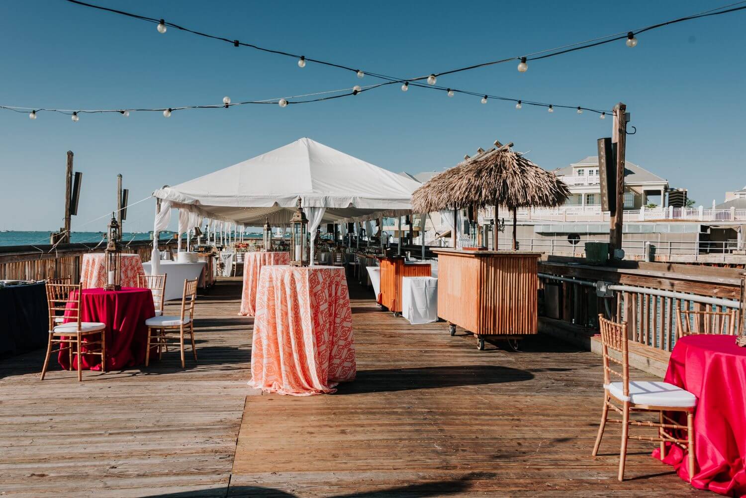 A wedding reception on the Ocean Key Resort pier with tables and chairs in Key West.
