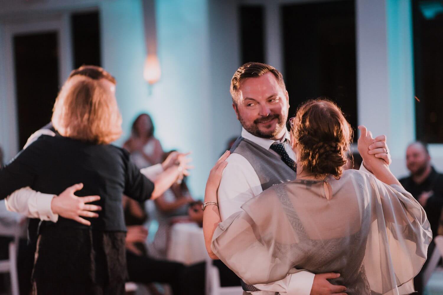 A man and woman dancing at a wedding reception at the Key West Hyatt Centric Resort.