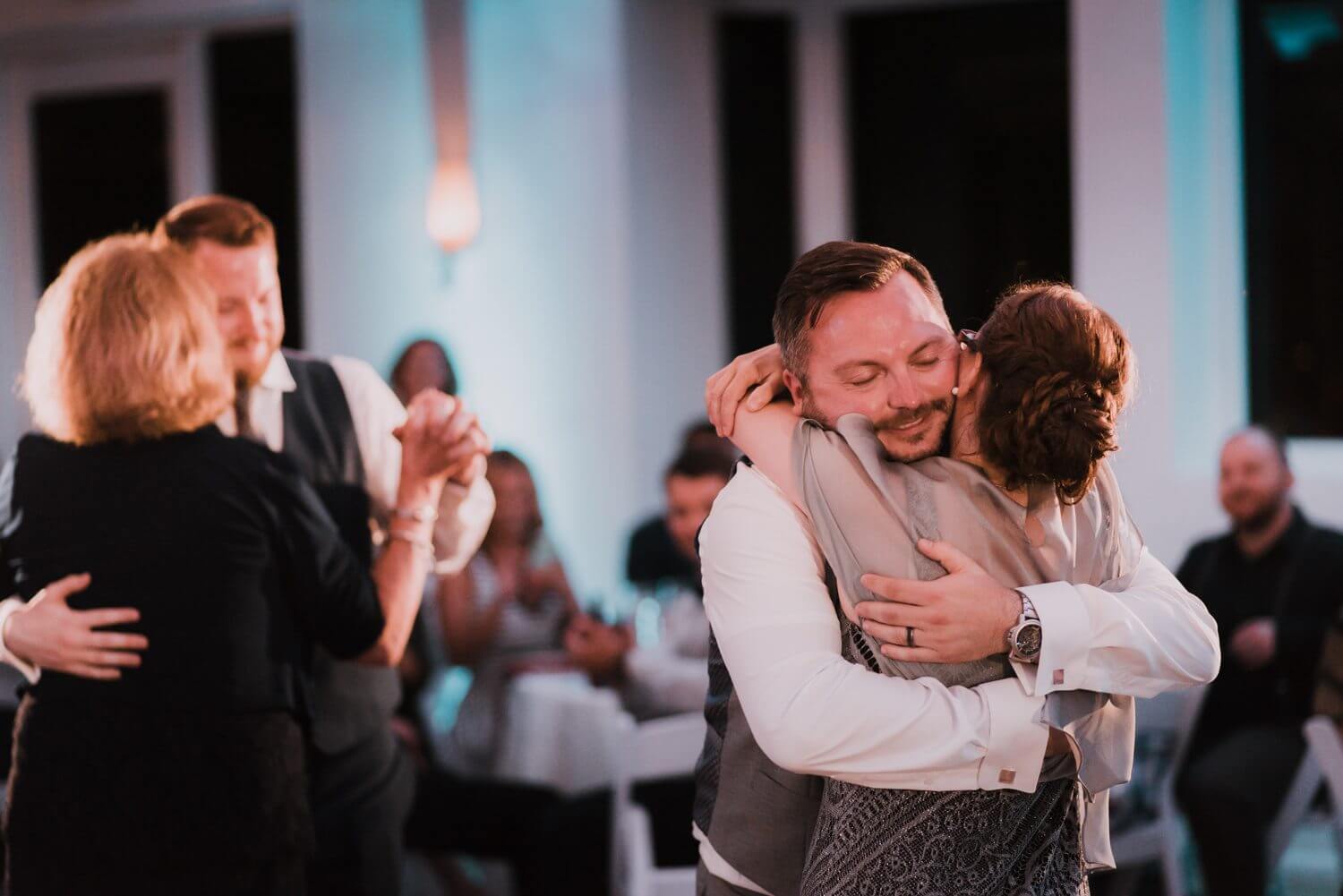 A bride and groom hugging during their Key West wedding reception.