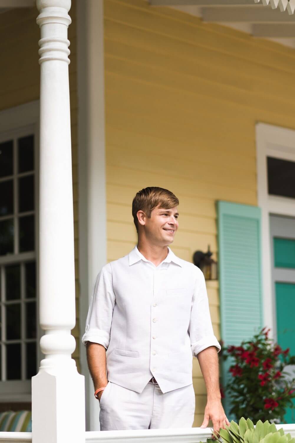 A young man standing on the porch of a Southernmost Mansion in Key West.