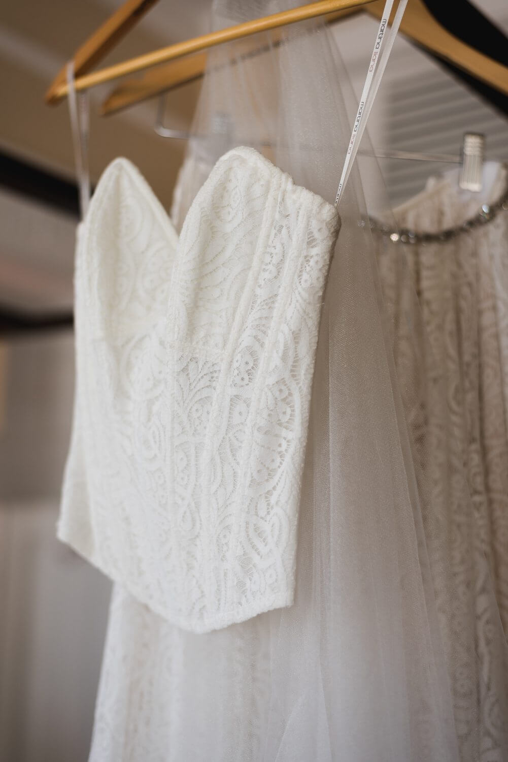 A white wedding dress hanging on a rack, perfect for a Key West wedding at the Southernmost Mansion.