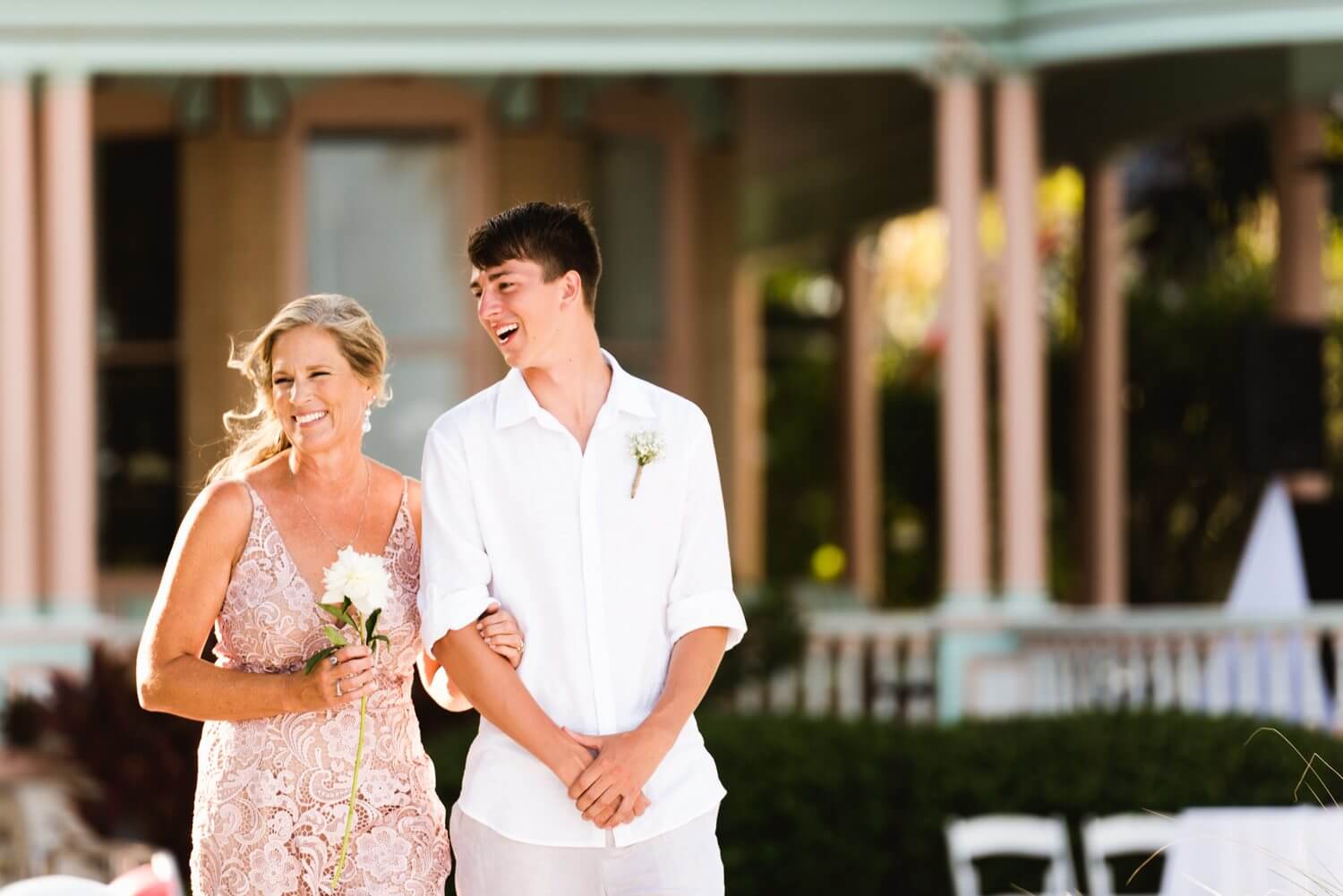 A bride and groom walking down the aisle at a southernmost mansion wedding in Key West.