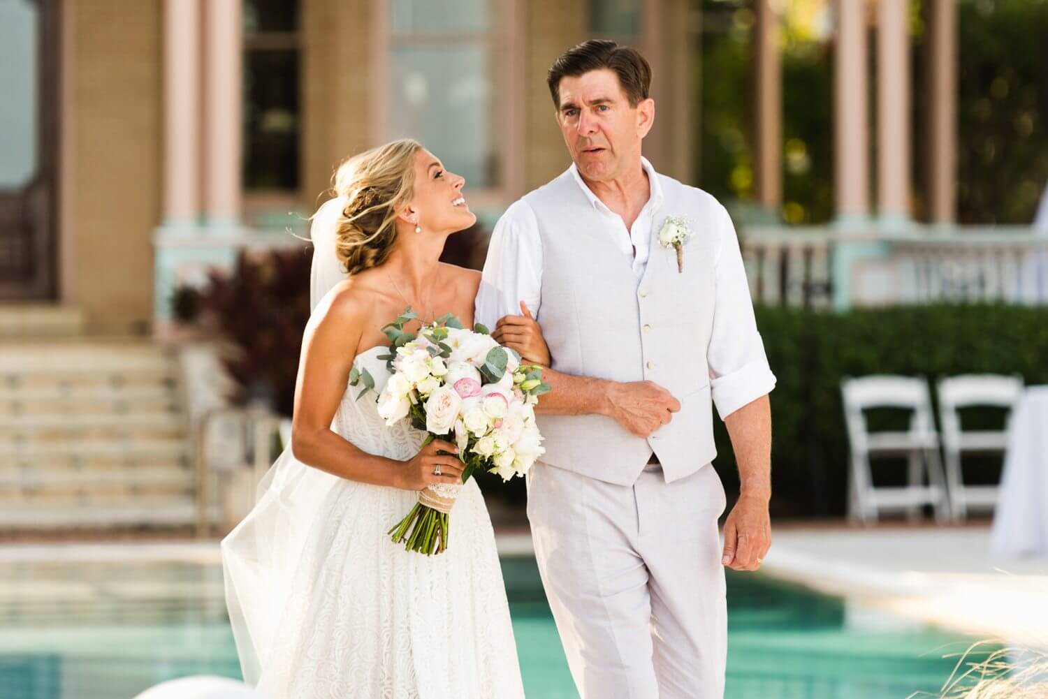A bride and groom standing next to a pool at their Southernmost Mansion Key West wedding.