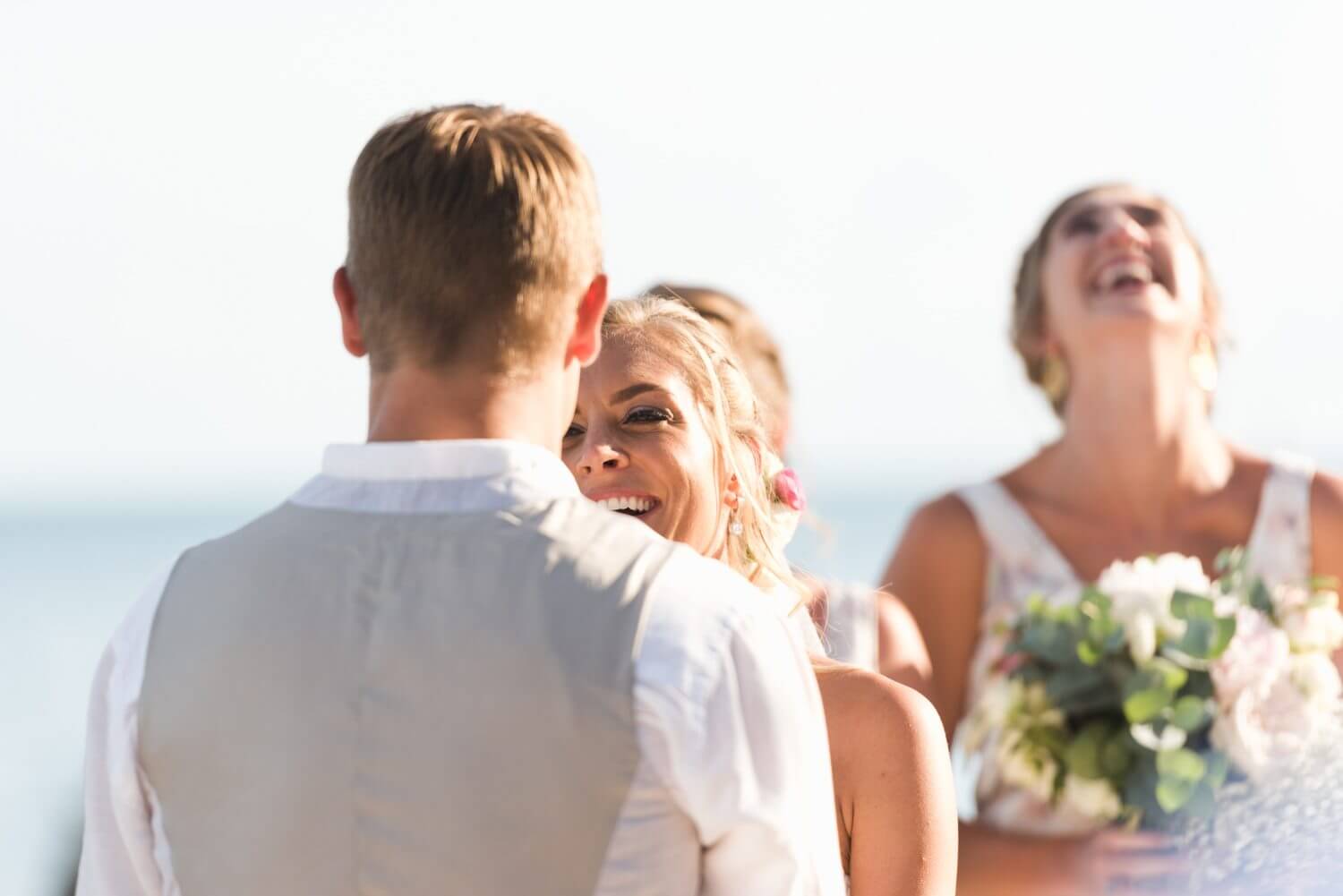 A bride and groom laughing at each other during their Key West wedding ceremony at the Southernmost Mansion.
