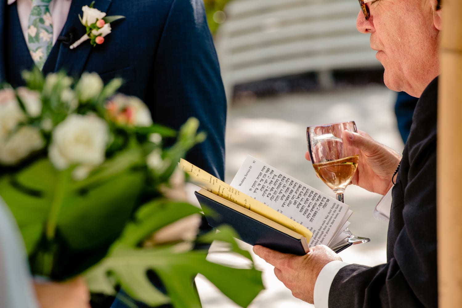 A man is reading a book at a wedding ceremony at Bakers Cay Resort.