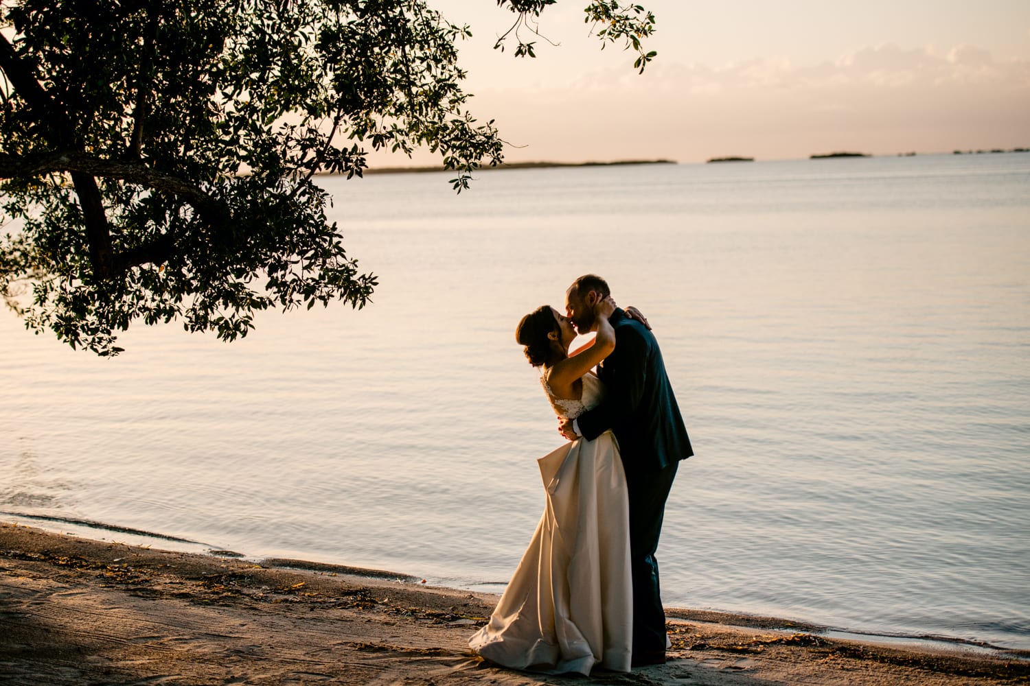 A wedding at Bakers Cay Resort with a sunset kiss by the water.