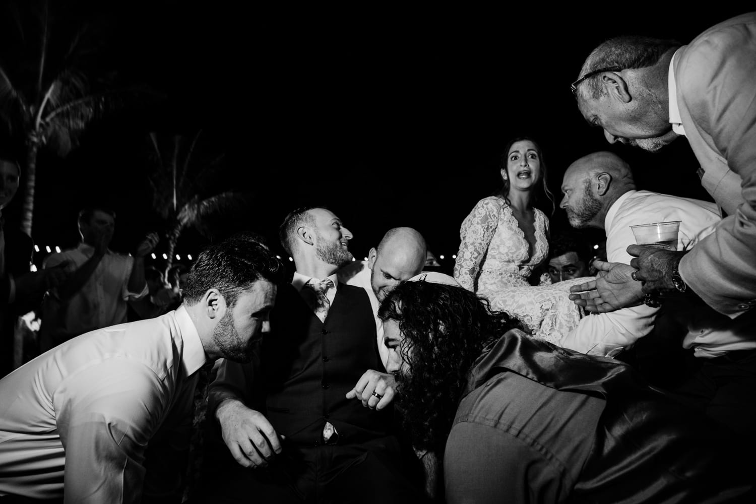 A black and white photo of a group of people at a wedding at Bakers Cay Resort.
