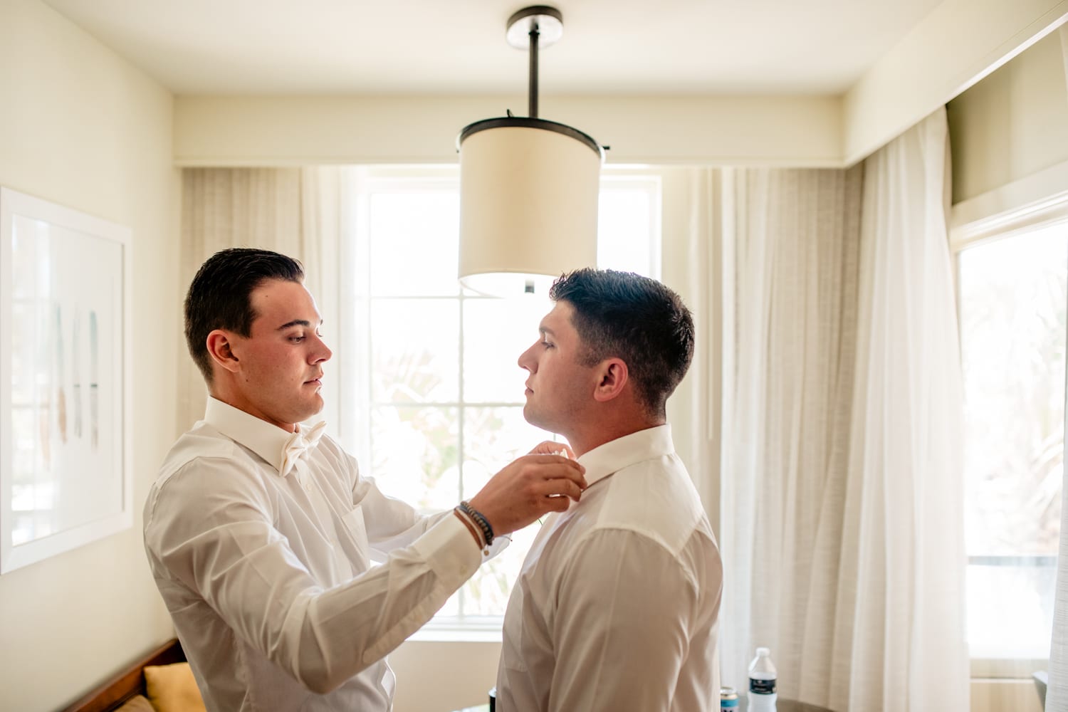 groom and groomsman party getting ready in rooms at casa marina resort key west