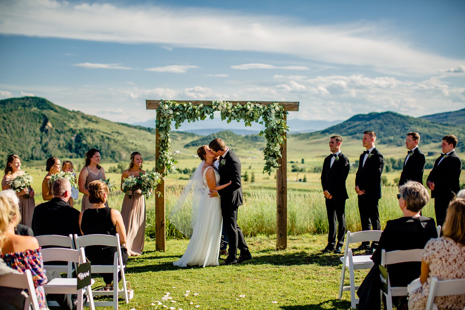 A bride and groom kiss during their Steamboat Springs wedding in the mountains.