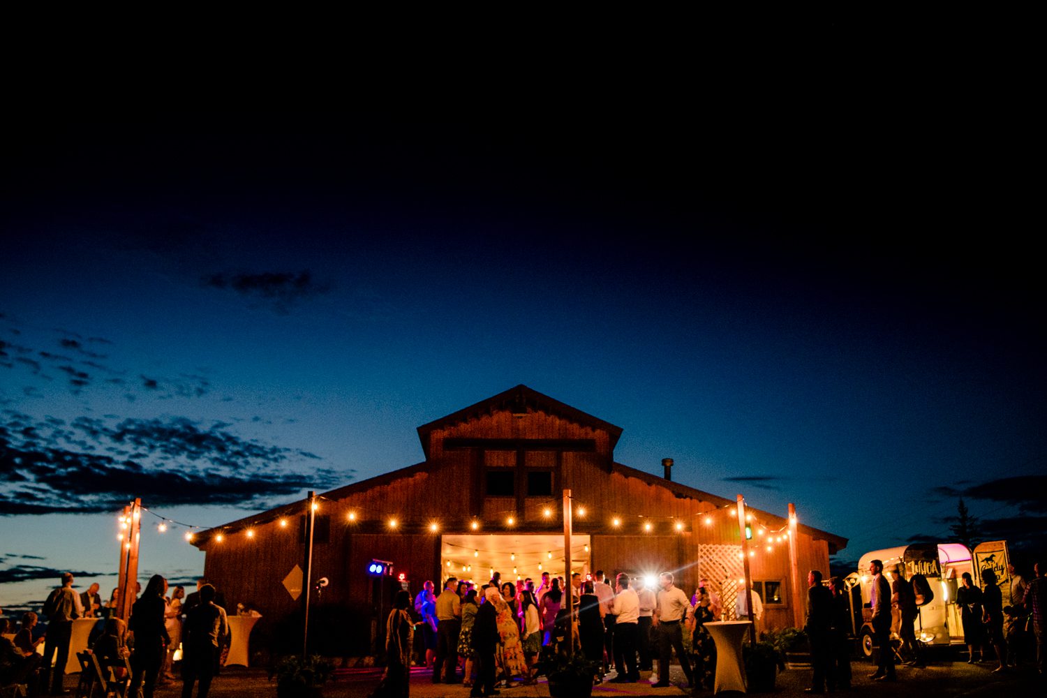 A barn wedding reception at dusk in Steamboat Springs.