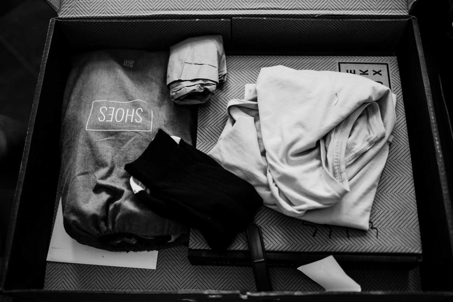 A black and white photo of clothes in a box in Steamboat Springs.