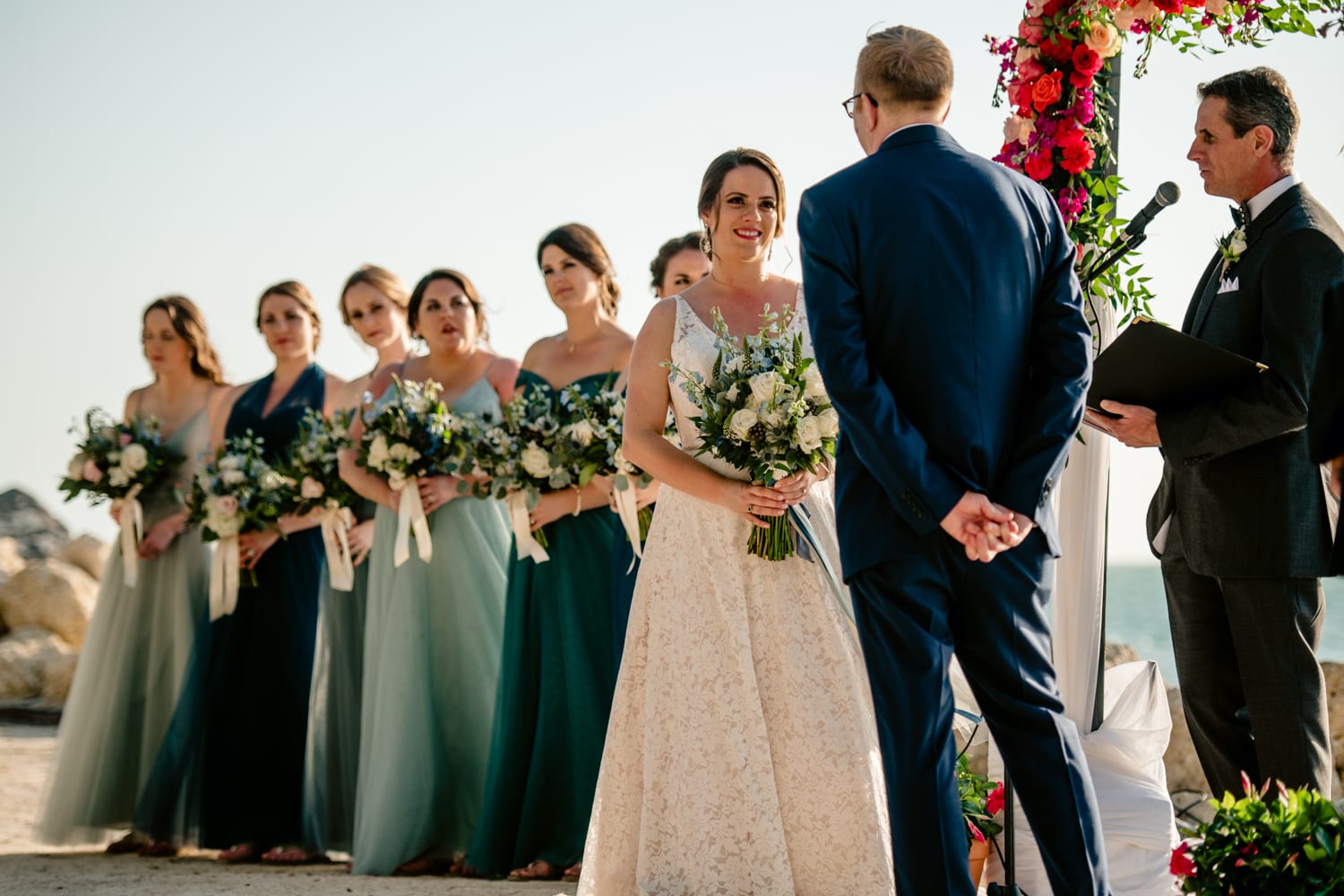 A fort zachary taylor wedding ceremony on the beach with bridesmaids and groomsmen.