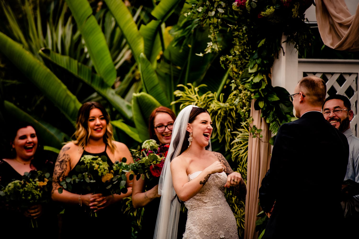 A Hemingway Home wedding with a laughing bride and groom during their ceremony.