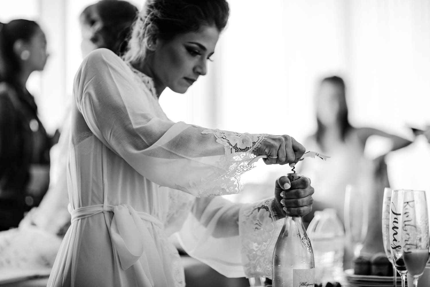 A woman pouring wine at the Eden Roc Resort in Miami for a wedding.