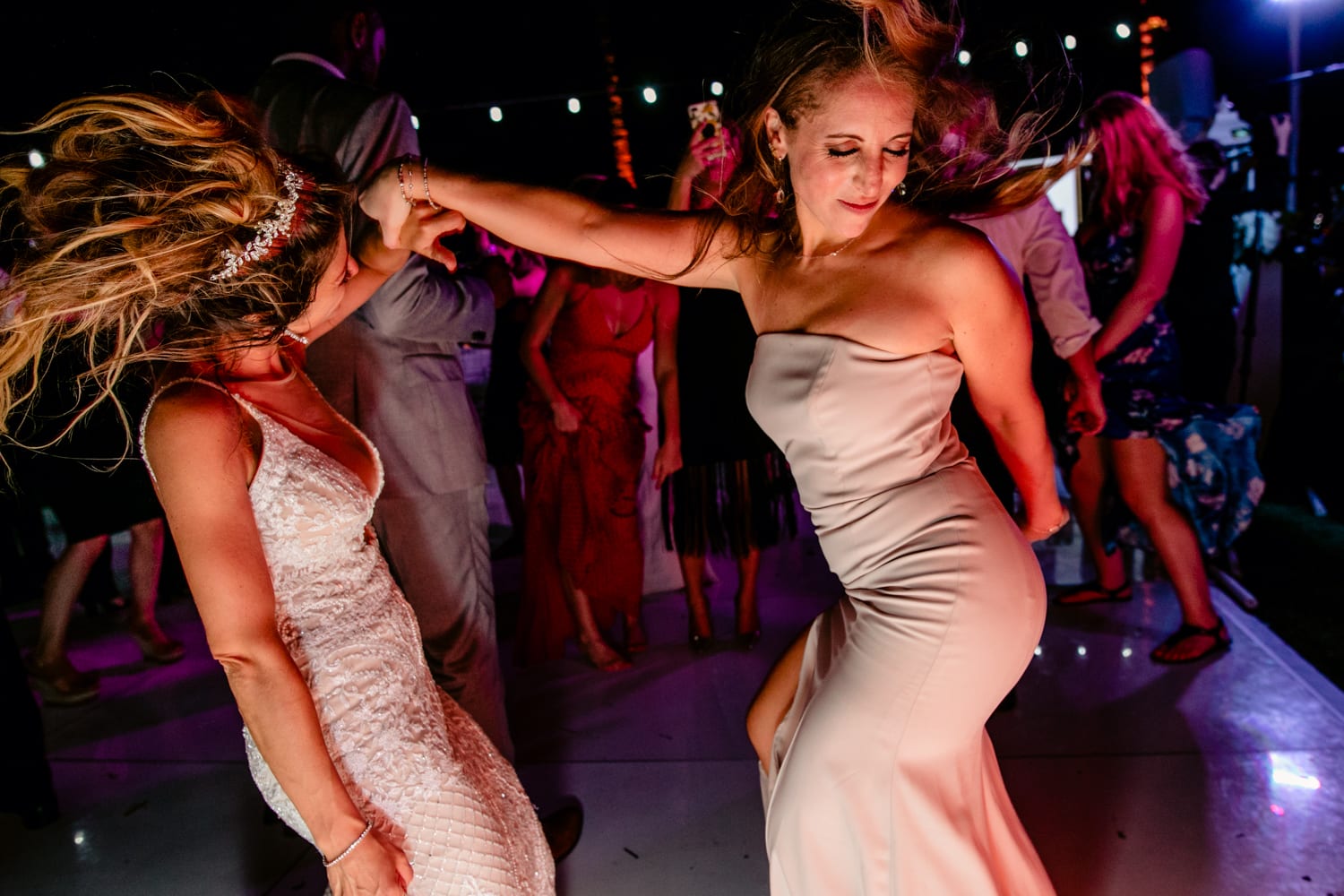 Two women dancing at a Miami wedding.
