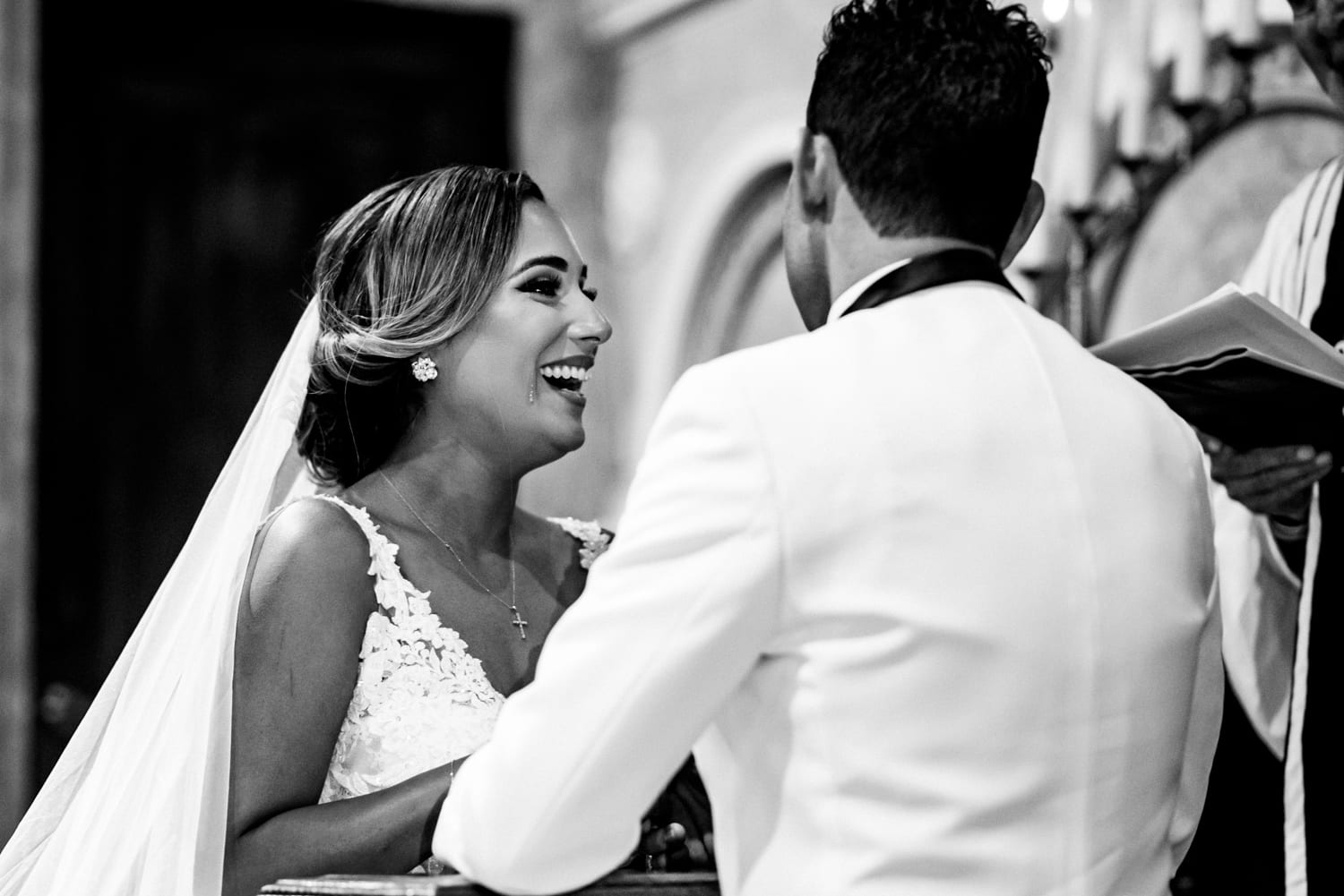 A couple smiling during their coral gables wedding ceremony.
