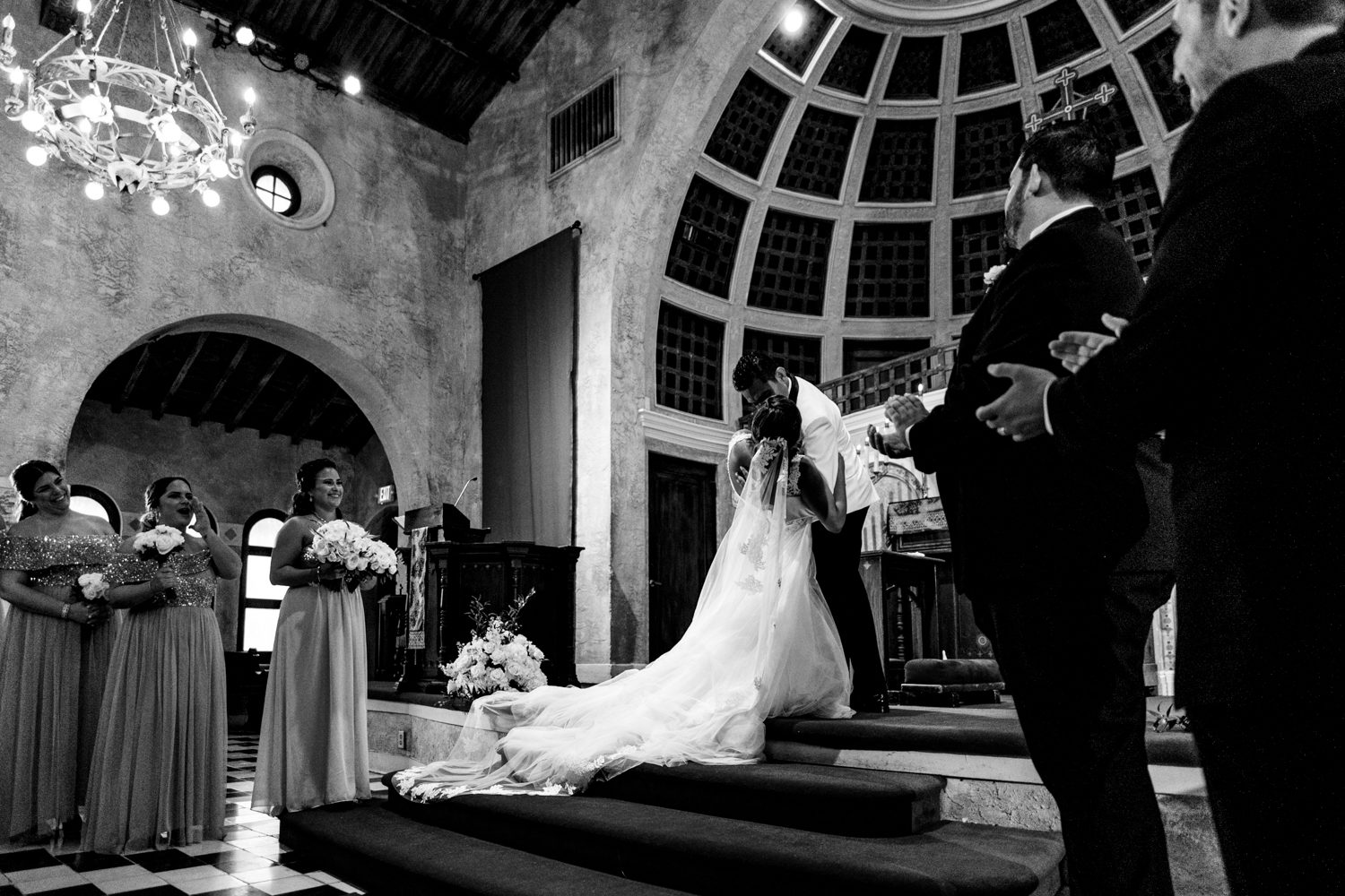A bride and groom exchange vows in a Miami Beach church captured by a Coral Gables wedding photographer.