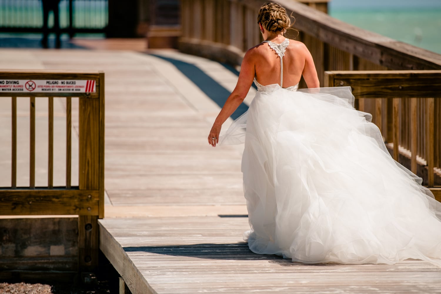 A bride walking down the pier during her Casa Marina wedding.