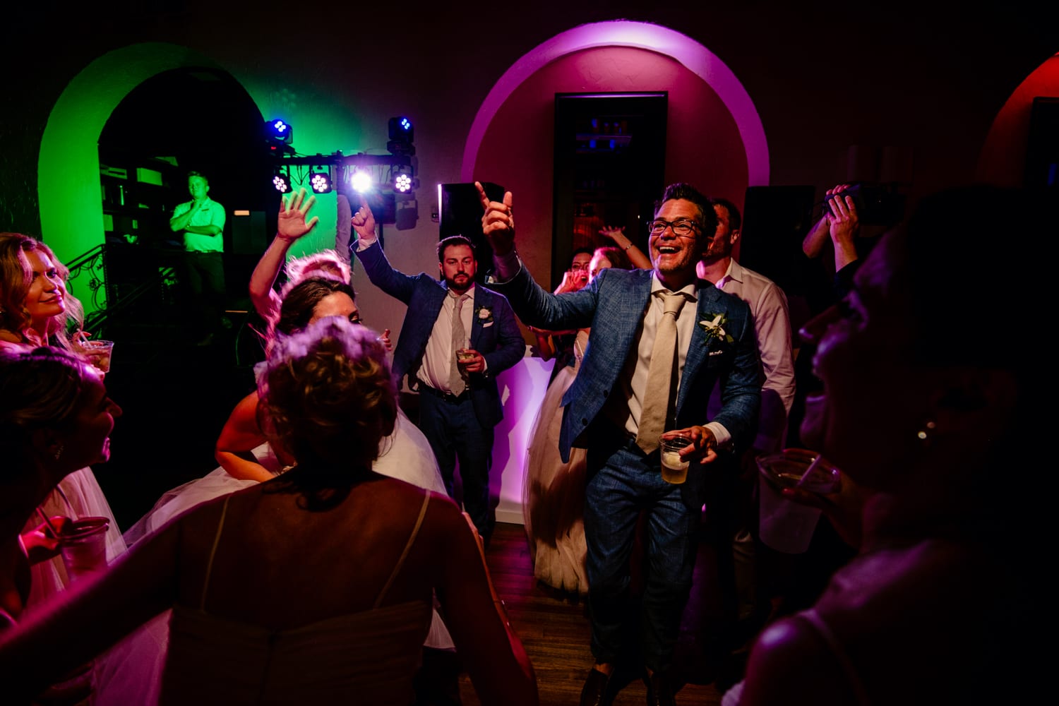 A group of people dancing at a wedding reception at Casa Marina.