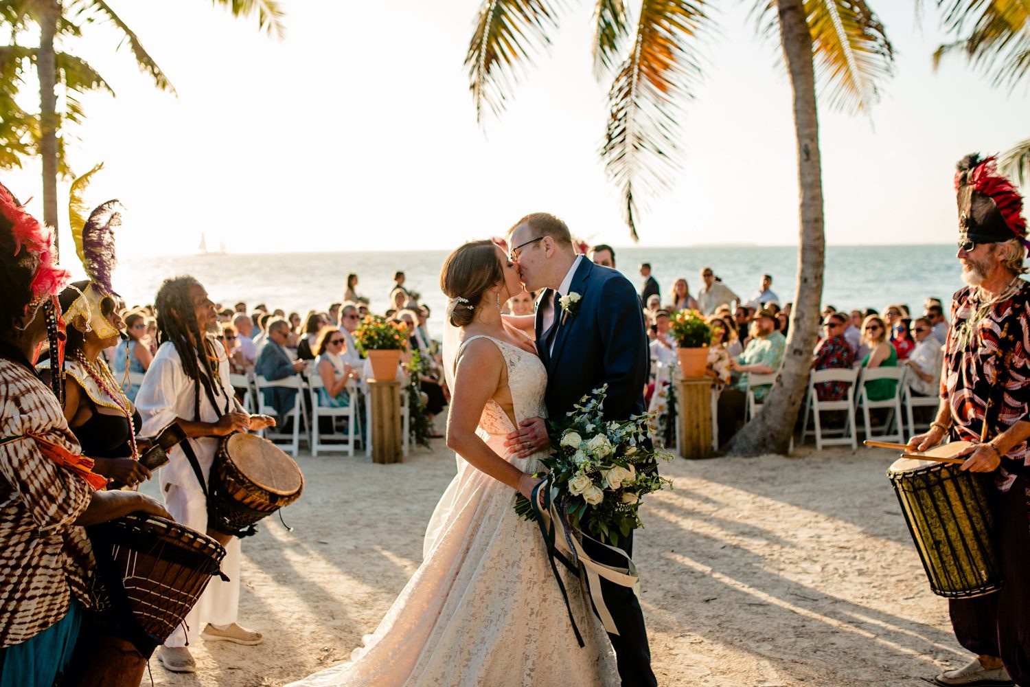 bride and groom kissing after being married at the point r2 wedding venue fort zachary taylor