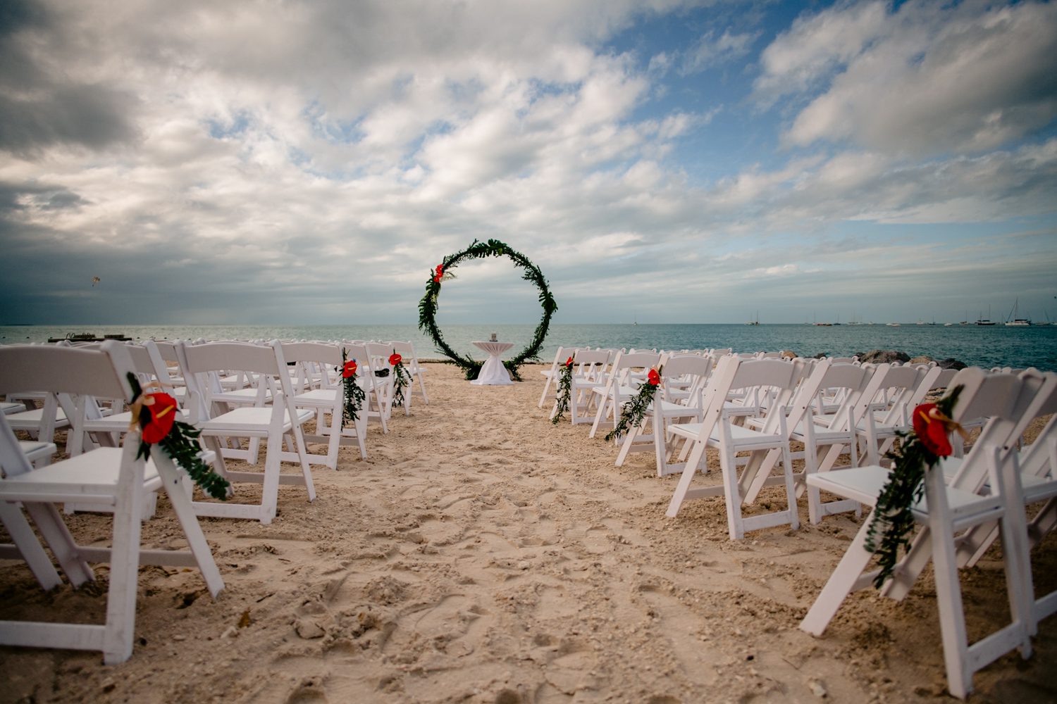 wedding ceremony setup photo of beach wedding sunset key