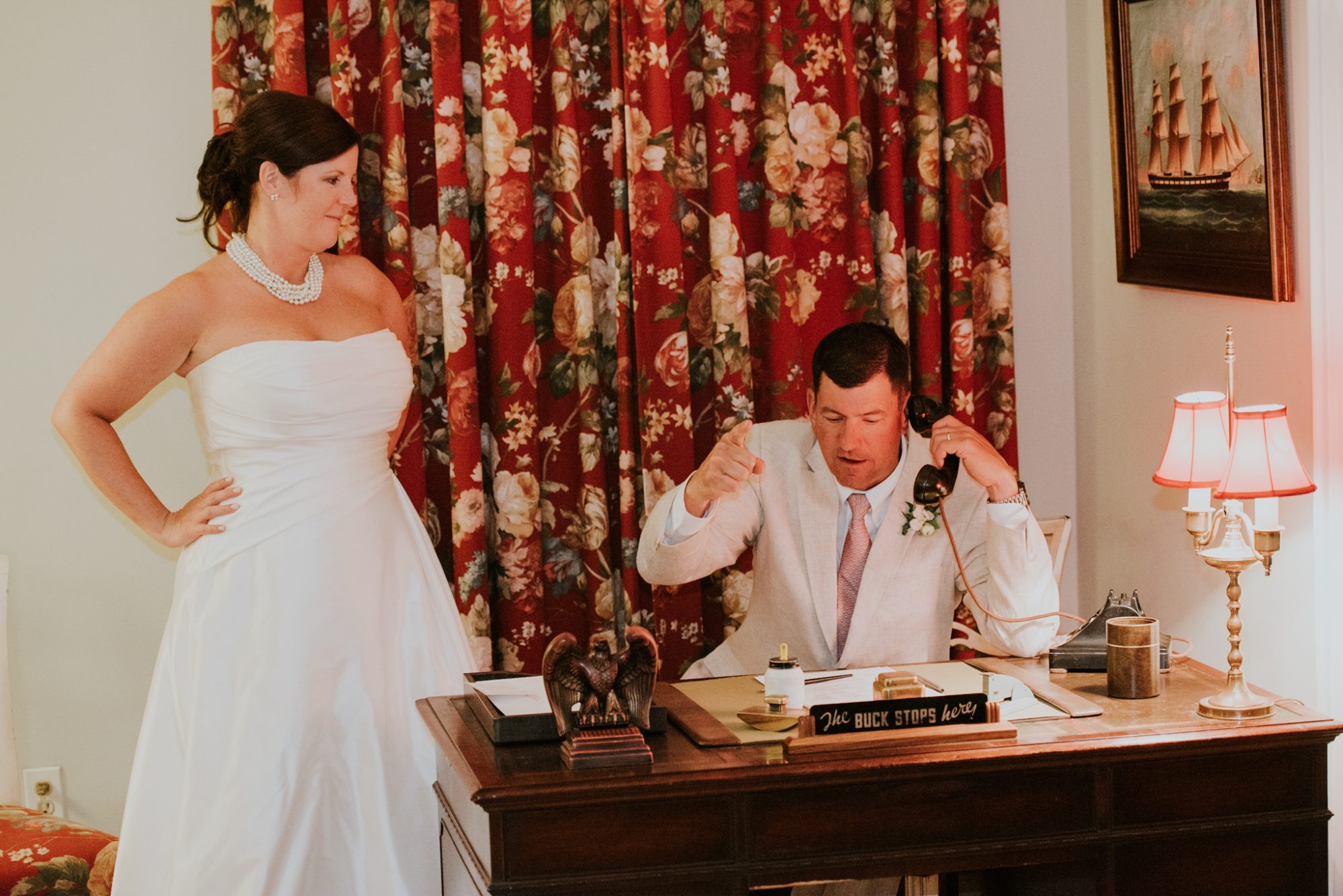A bride and groom talking on the phone in the Truman White House.