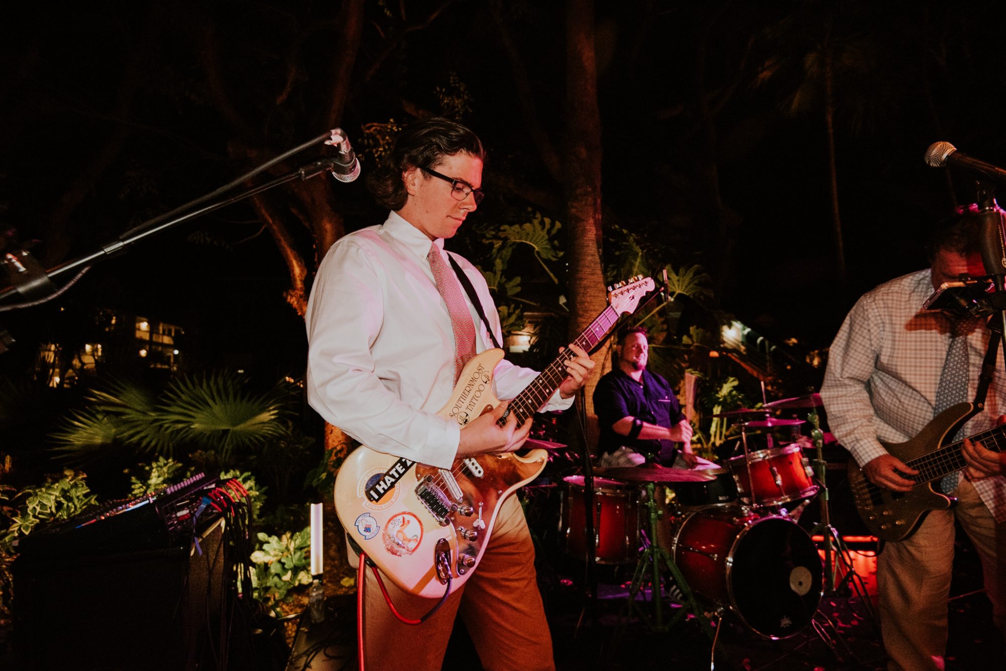 A group of men playing guitars at a Truman White House wedding in Key West at night.