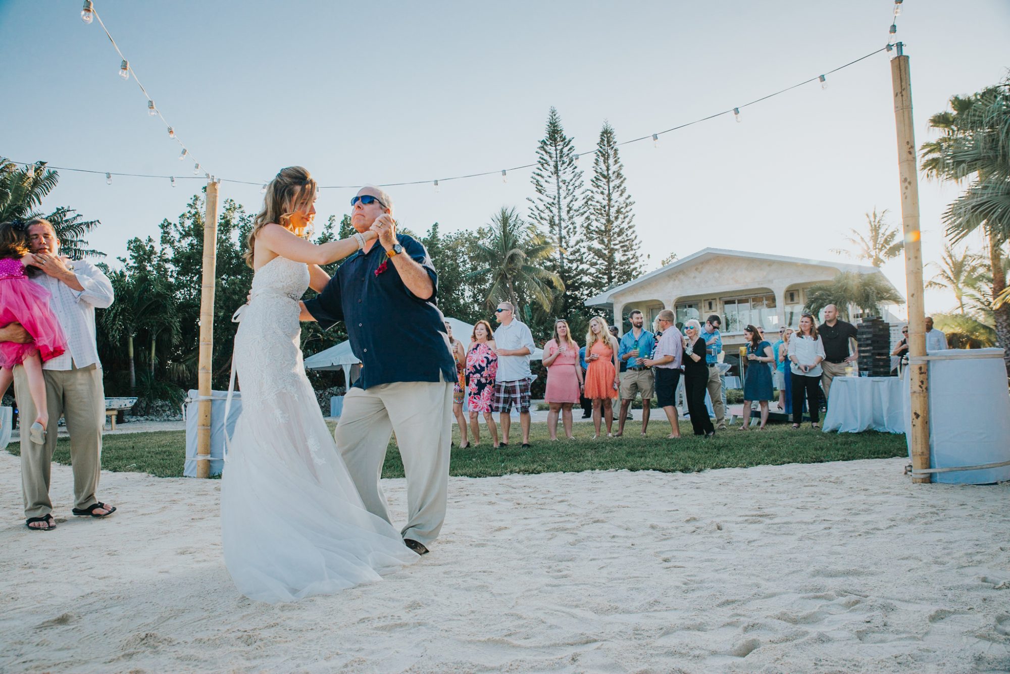 A bride and groom having a destination wedding in the Florida Keys, dancing on the beach.