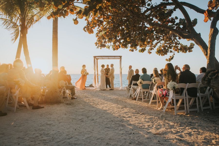 A Key West wedding ceremony on the beach at sunset captured by a skilled photographer.