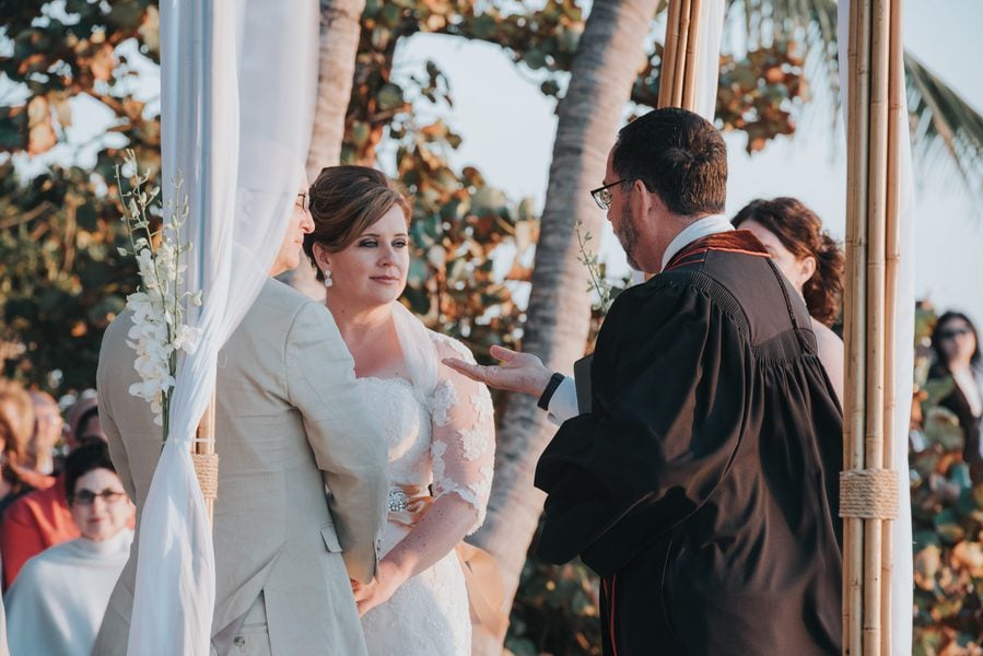 A couple exchange vows at a picturesque Fort Zachary Taylor wedding.